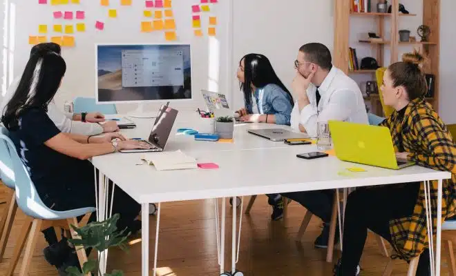 five person by table watching turned on white iMac