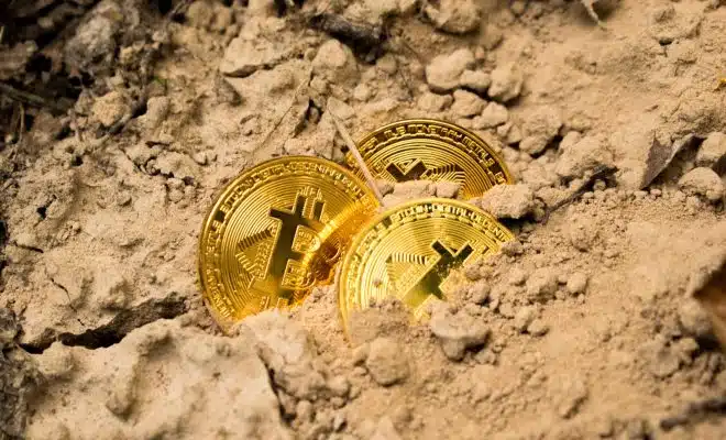 three Bitcoins on soil